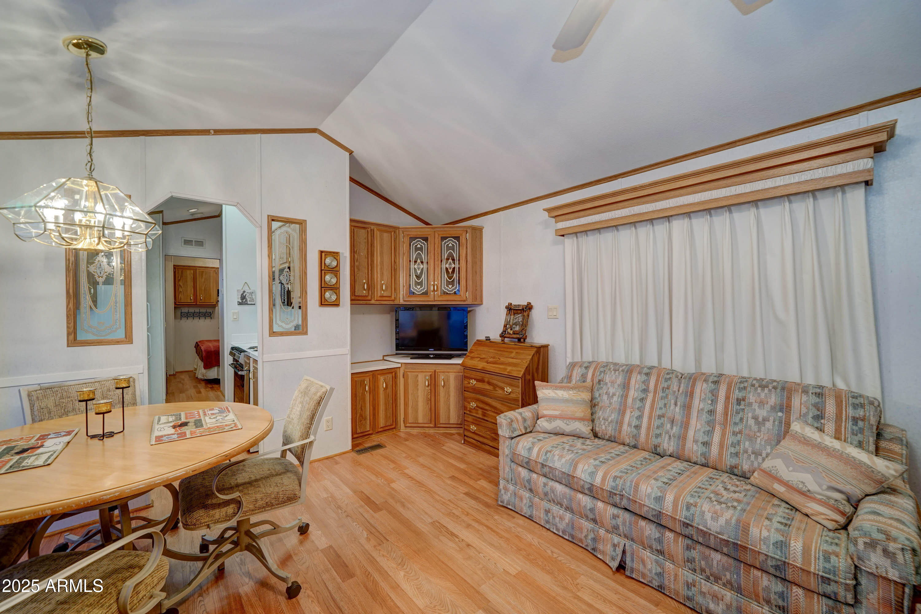 111 South Greenfield Road, Unit 405 Mesa, AZ 85206 - Photo 2 of 22 a living room with furniture and a chandelier