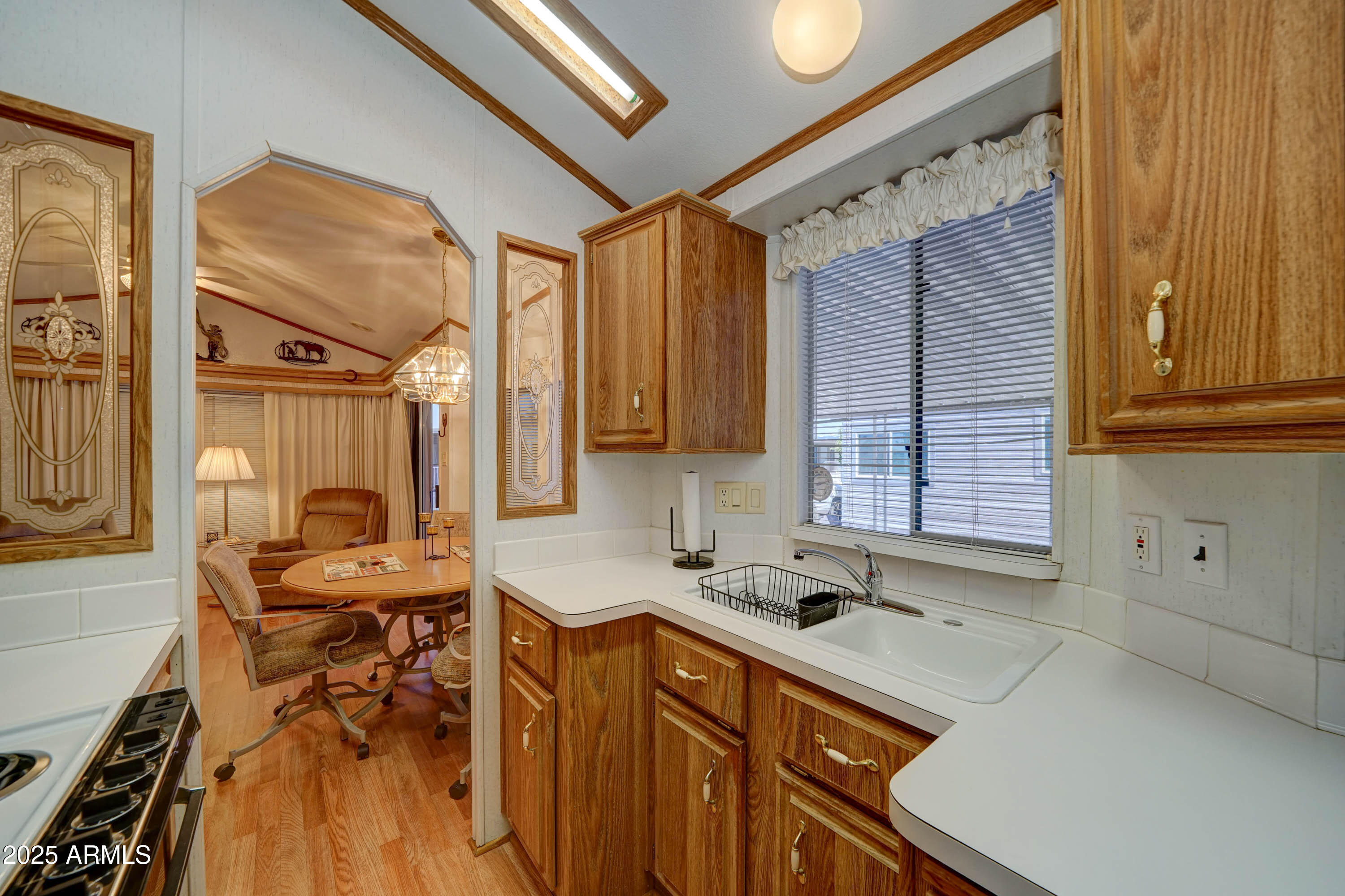 111 South Greenfield Road, Unit 405 Mesa, AZ 85206 - Photo 5 of 22 a kitchen that has a sink and a stove in it