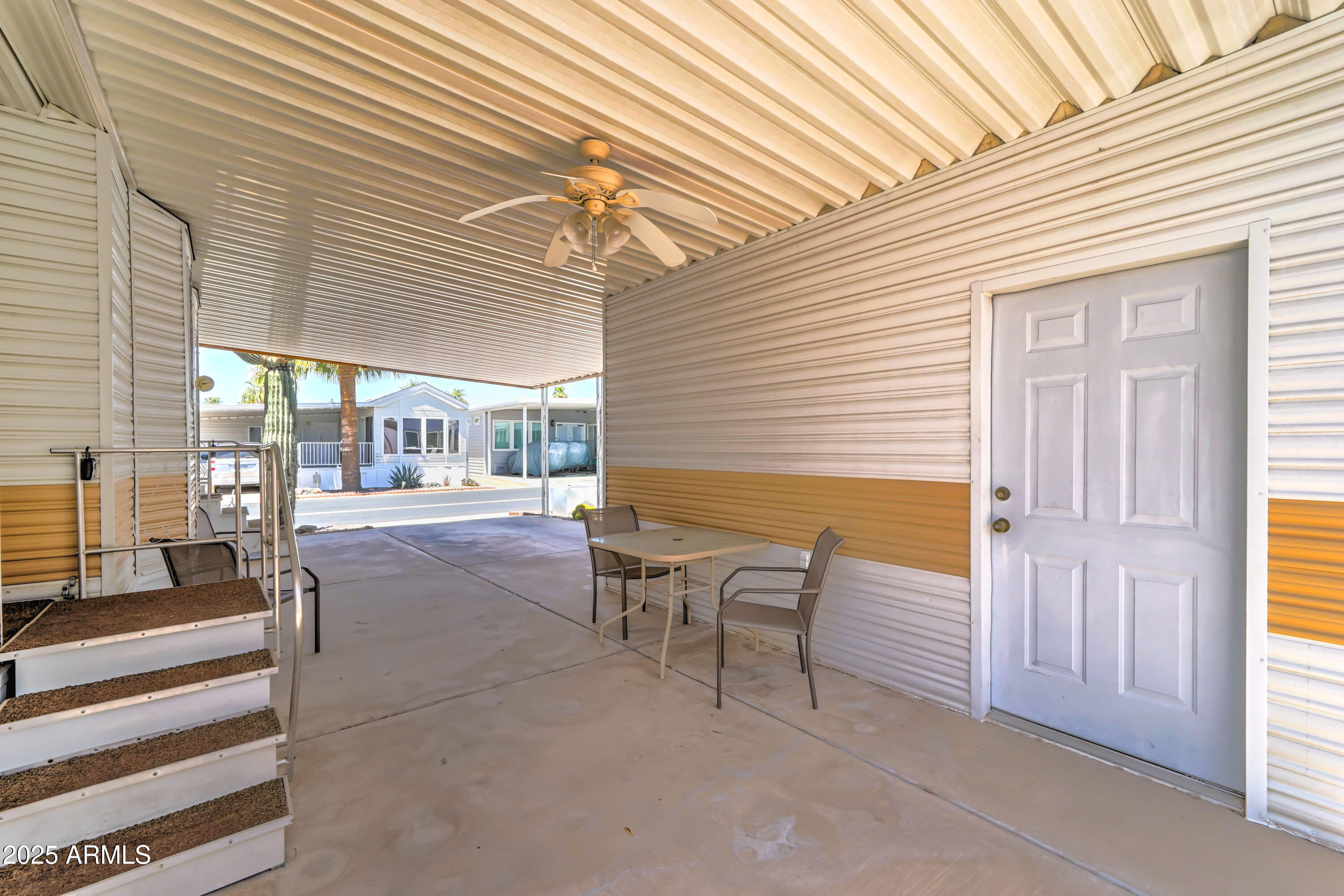 111 South Greenfield Road, Unit 405 Mesa, AZ 85206 - Photo 9 of 22 a view of a patio with table and chairs and wooden floor
