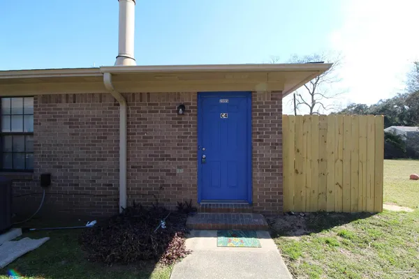 a view of house with backyard space and wooden fence