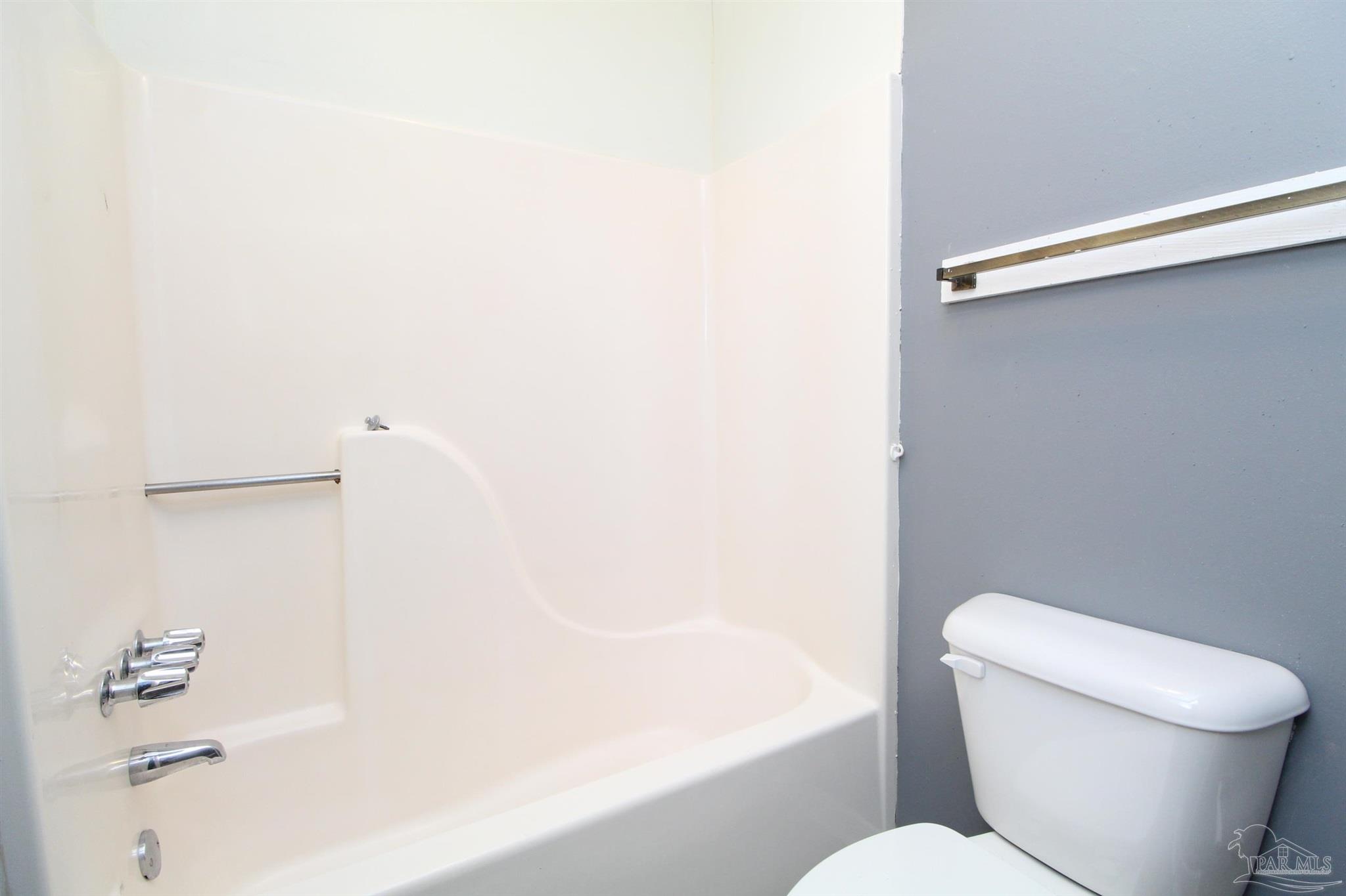 2995 Junction Drive, Unit C4 Cantonment, FL 32533 - Photo 13 of 14 a white toilet sitting next to a bath tub