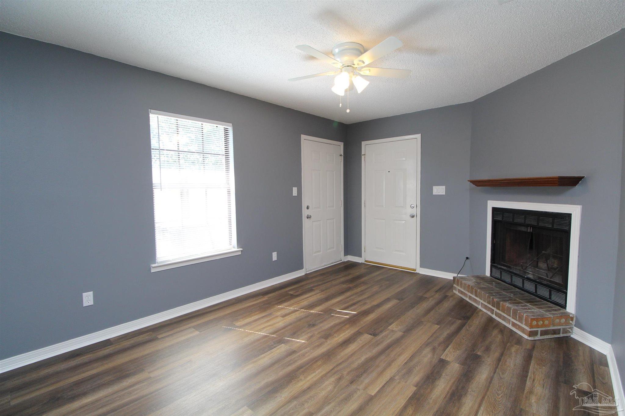 2995 Junction Drive, Unit C4 Cantonment, FL 32533 - Photo 2 of 14 a view of an empty room with a window and fireplace