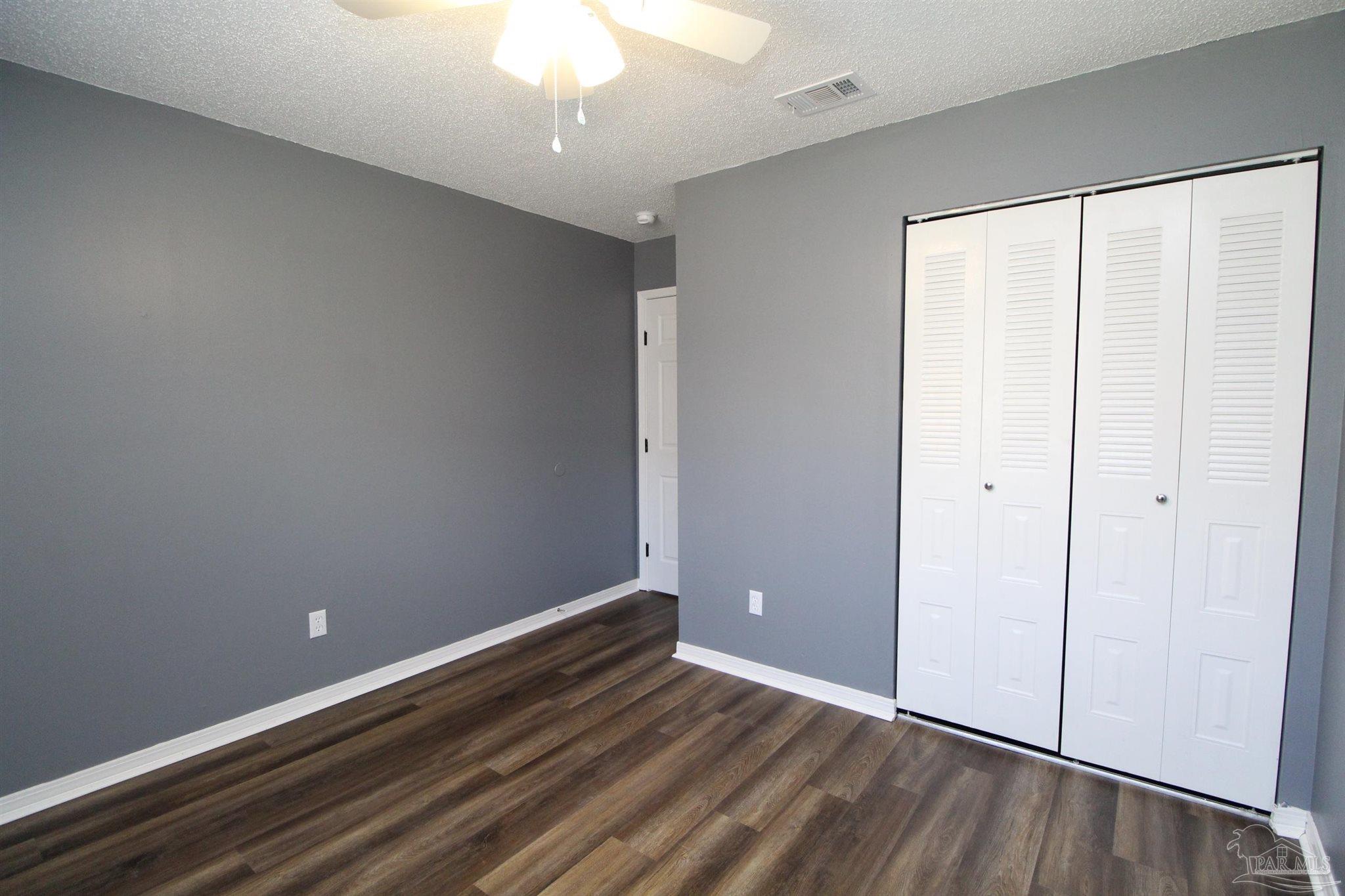 2995 Junction Drive, Unit C4 Cantonment, FL 32533 - Photo 8 of 14 wooden floor in an empty room