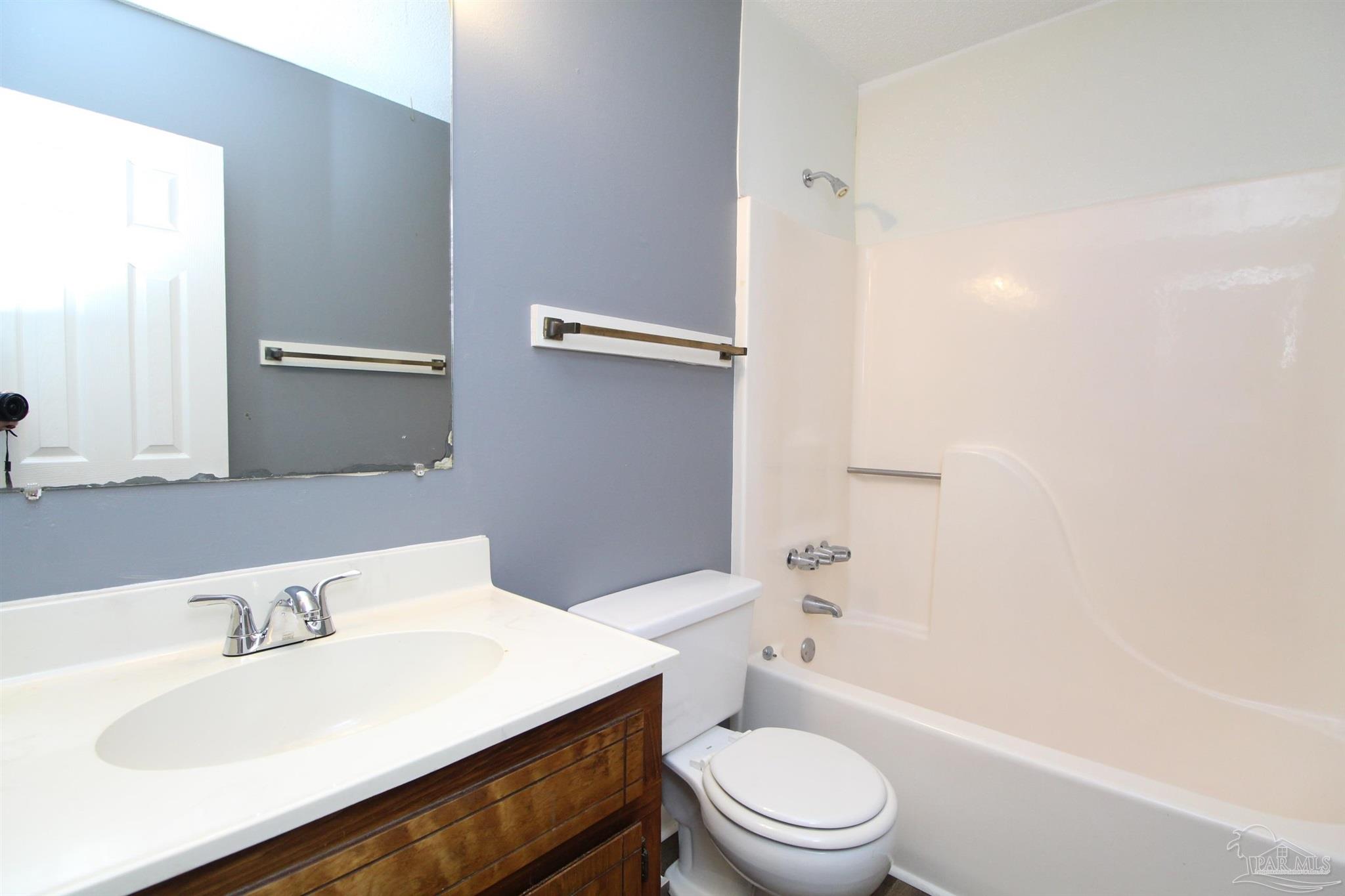 2995 Junction Drive, Unit C4 Cantonment, FL 32533 - Photo 9 of 14 a bathroom with a sink toilet and shower