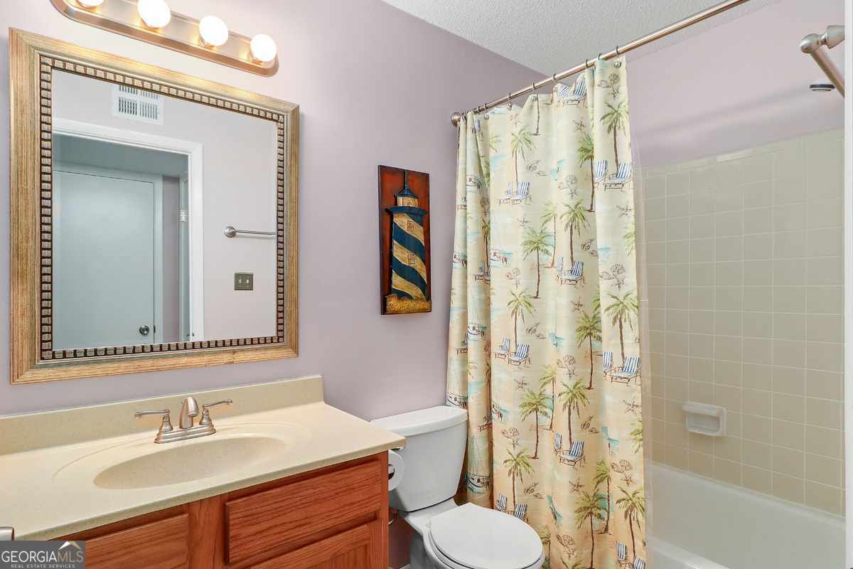 401 North Cromwell Road, Unit 2Q Savannah, GA 31410 - Photo 23 of 35 a bathroom with a sink and a mirror