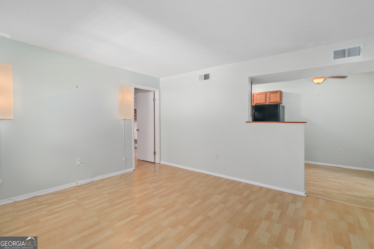 401 North Cromwell Road, Unit 2Q Savannah, GA 31410 - Photo 8 of 35 a view of an empty room with wooden floor and a window