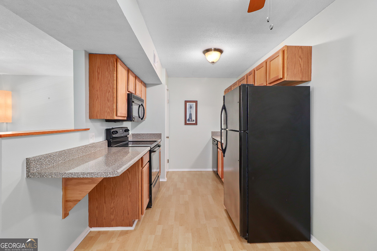 401 North Cromwell Road, Unit 2Q Savannah, GA 31410 - Photo 10 of 35 a kitchen with stainless steel appliances granite countertop a refrigerator and a sink