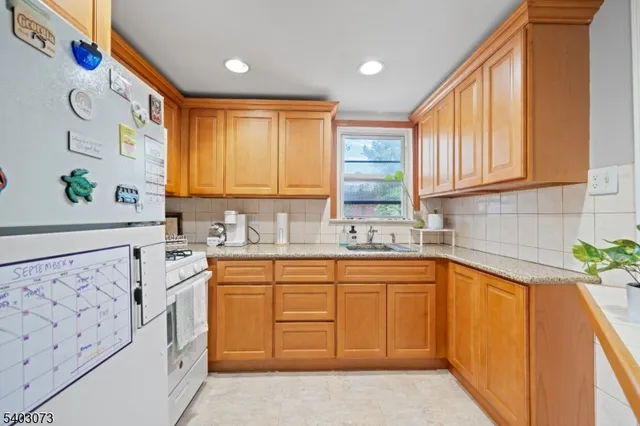a kitchen with a sink dishwasher a stove and a refrigerator