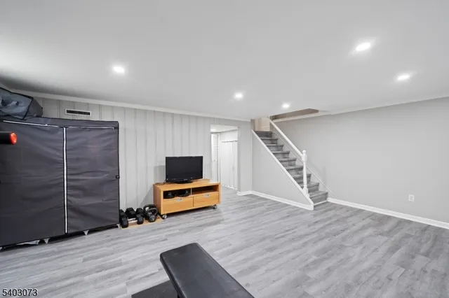 a view of a livingroom with wooden floor and furniture