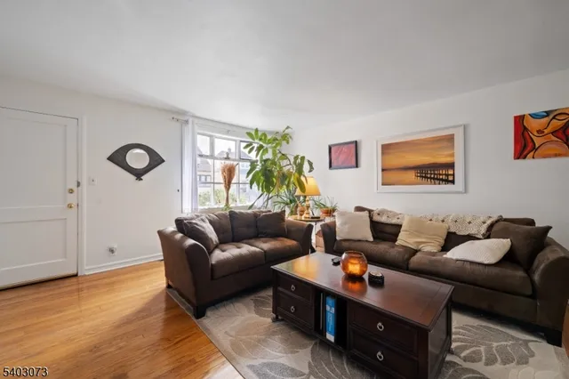 a living room with furniture a rug and a window