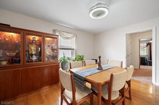 a dining room with furniture large windows and a chandelier