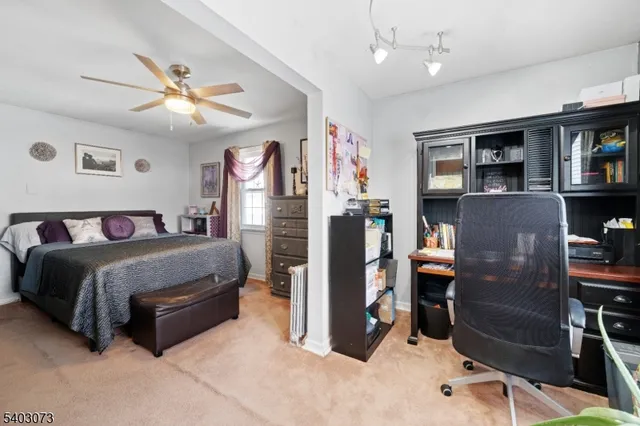 a spacious bedroom with a bed and dresser