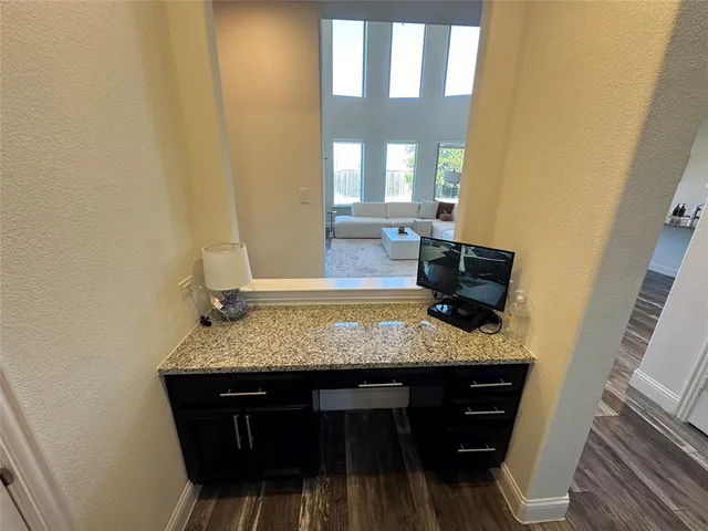 a spacious bathroom with a granite countertop sink mirror and toilet