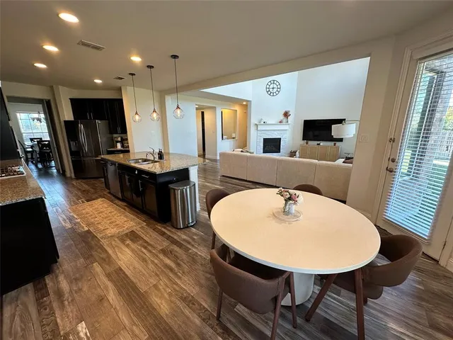a dining room with furniture and wooden floor