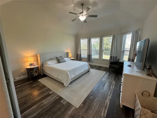 a bedroom with a bed and a television