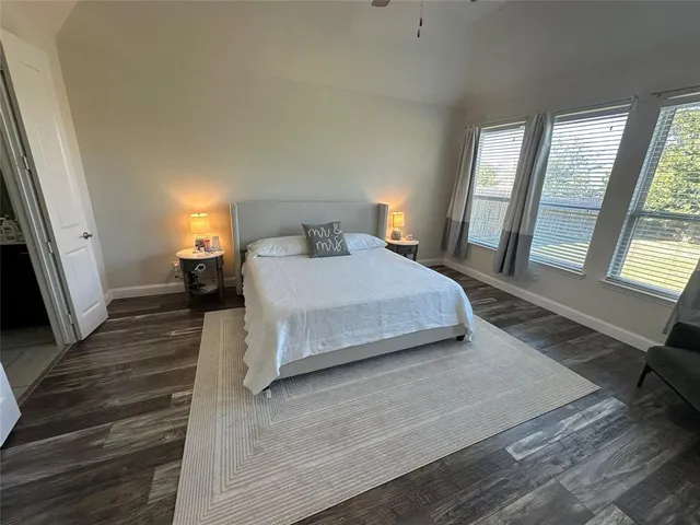 a bedroom with a bed window and a flat screen television