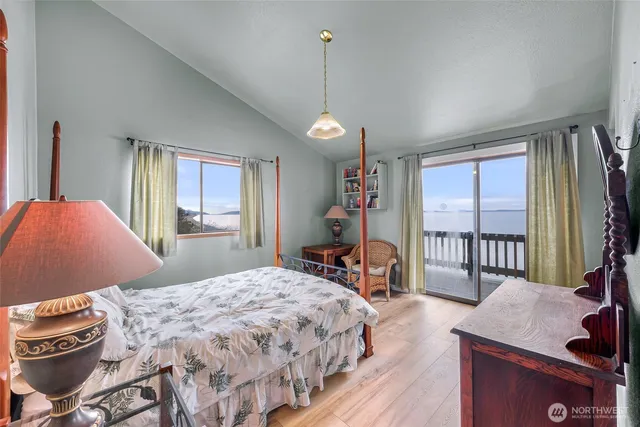 a bedroom with a bed and a dresser with mirror