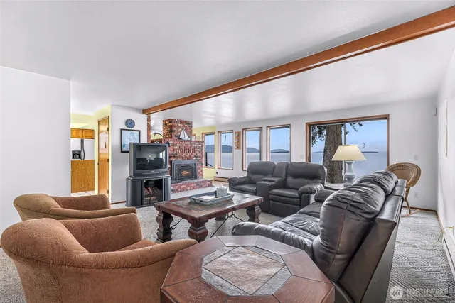 a living room with furniture kitchen and a table