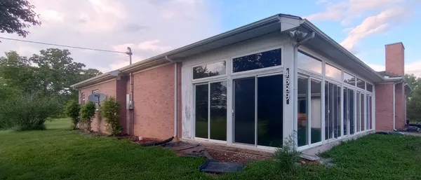 a view of a house with brick walls and a small yard