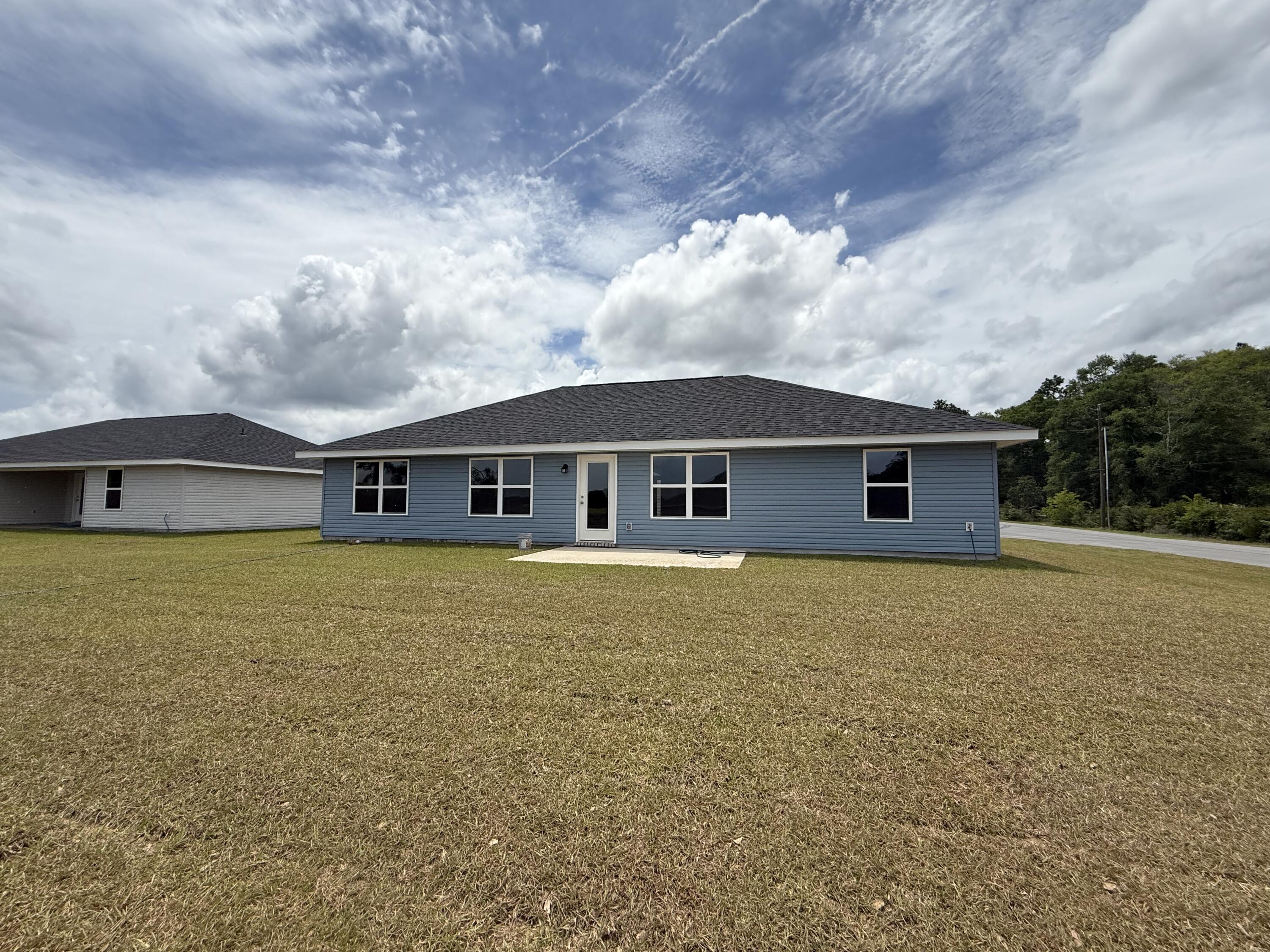 6000 Crocket Cove Crestview, FL 32539 - Photo 19 of 20 a front view of house with yard and trees in the background
