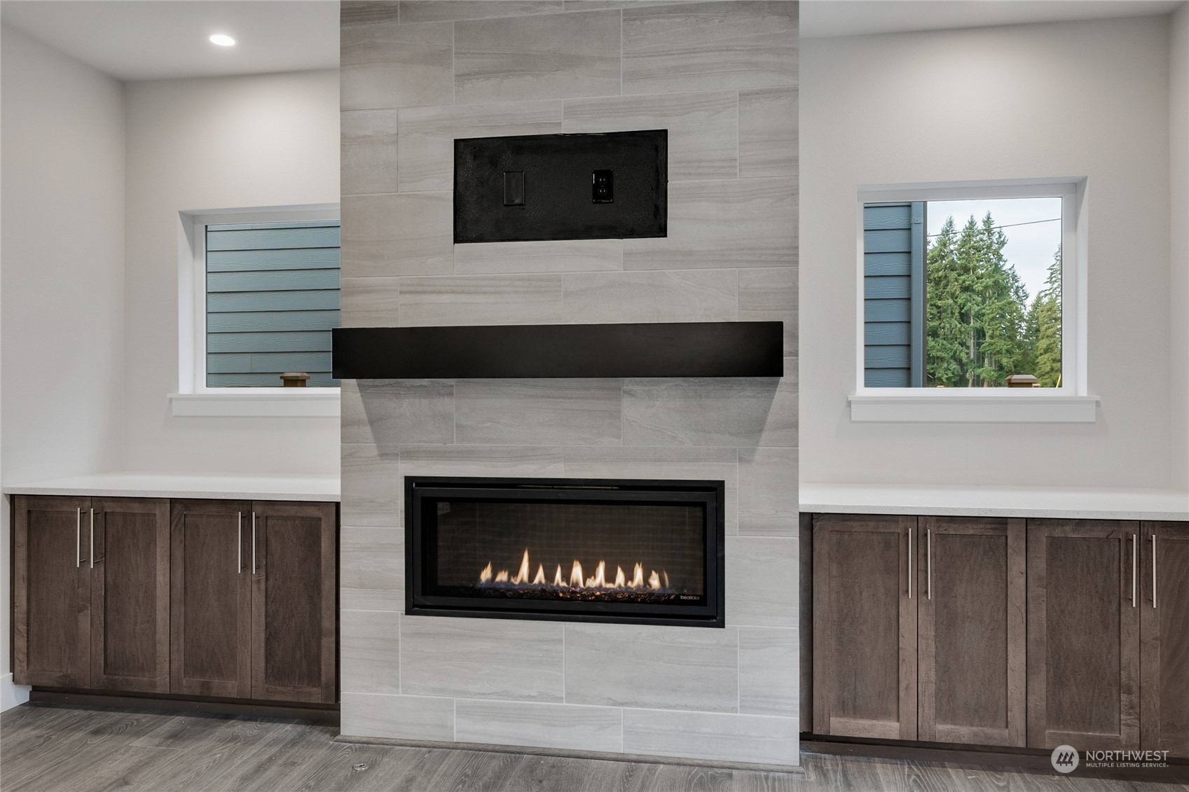111 177th Street Southeast Bothell, WA 98012 - Photo 14 of 34 a living room with a fireplace and a flat screen tv