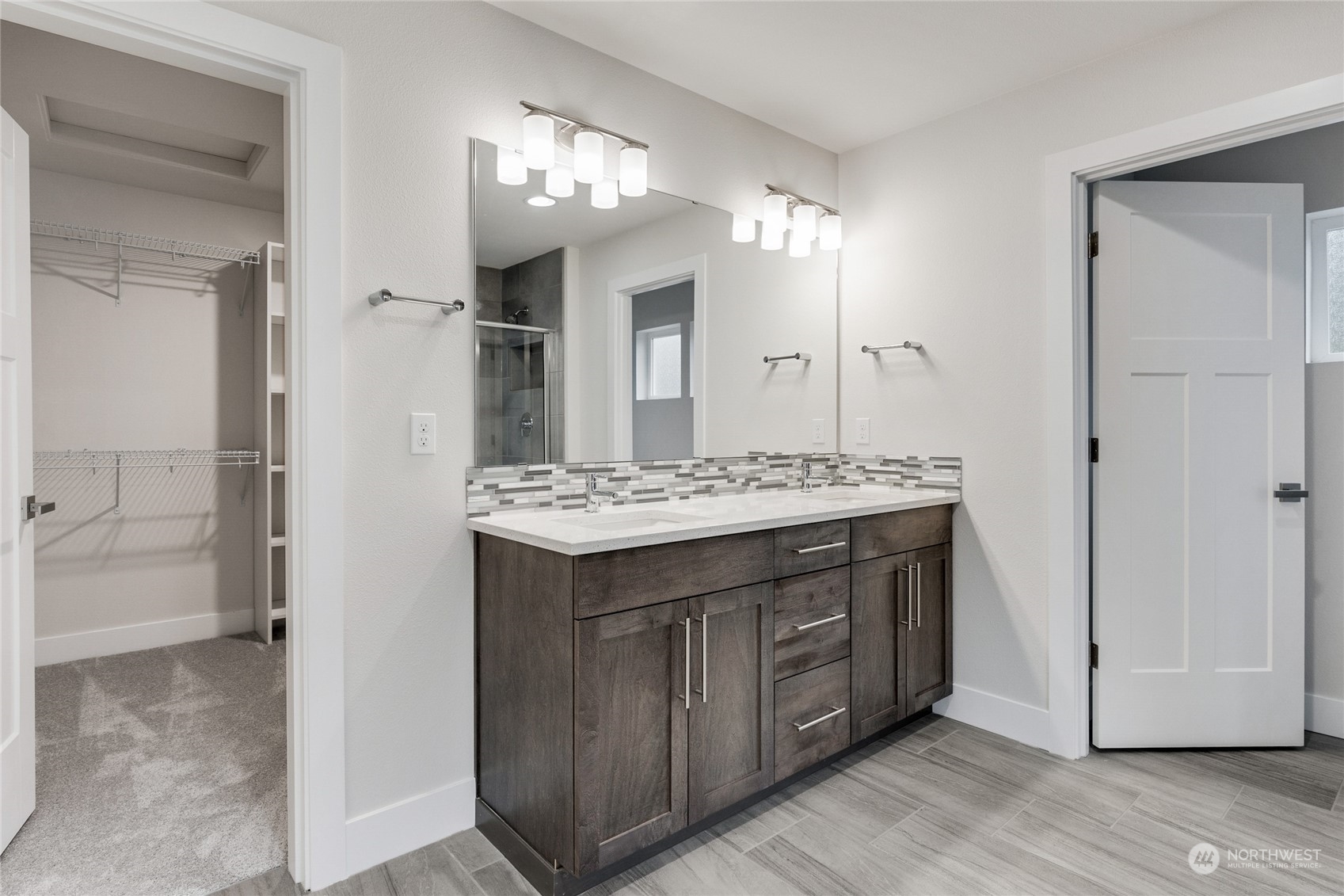 111 177th Street Southeast Bothell, WA 98012 - Photo 23 of 34 a bathroom with a granite countertop sink a large mirror and a shower