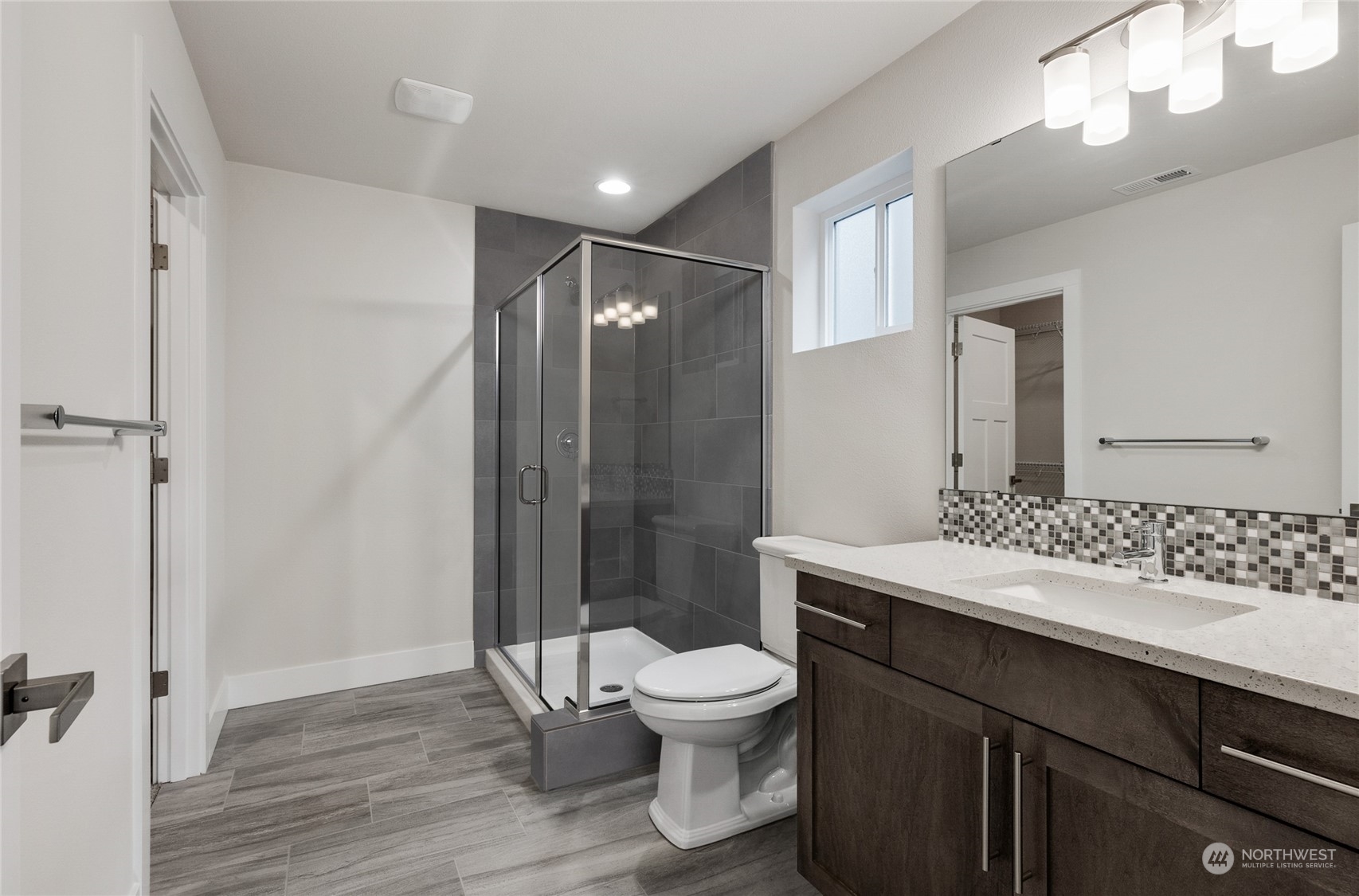 111 177th Street Southeast Bothell, WA 98012 - Photo 9 of 34 a bathroom with a sink a toilet a mirror and shower