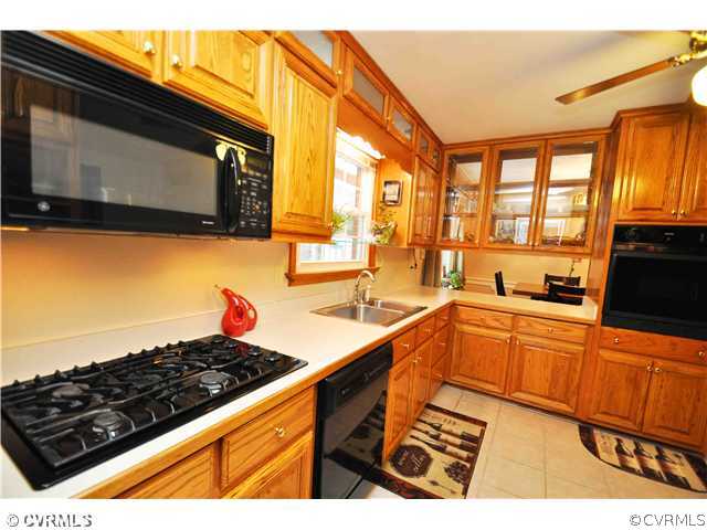 11600 Winterpock Road Chesterfield, VA 23838 - Photo 3 of 10 a kitchen with stainless steel appliances kitchen island granite countertop a sink and a stove