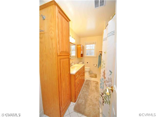 11600 Winterpock Road Chesterfield, VA 23838 - Photo 7 of 10 a view of a bathroom with a shower curtain
