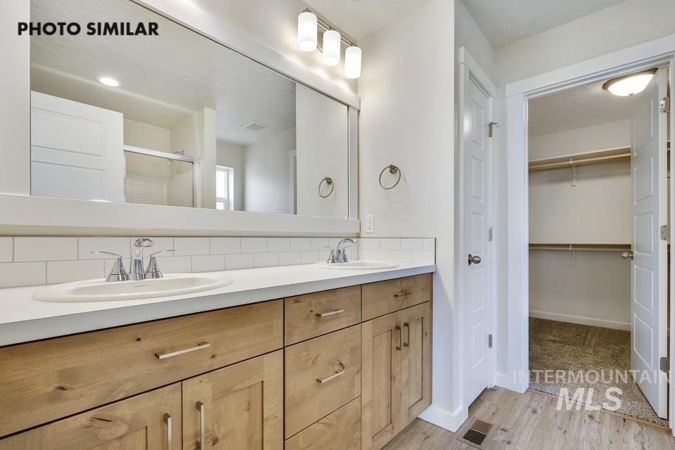 1652 Haystack Road Emmett, ID 83617 - Photo 16 of 29 Dual vanity featuring light wood-finish cabinetry, white countertops, and chrome fixtures