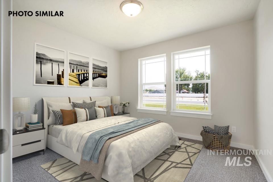 1652 Haystack Road Emmett, ID 83617 - Photo 22 of 29 Bedroom featuring dual windows, light gray walls, and carpet flooring