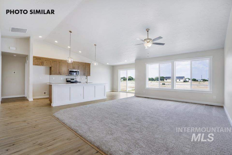 1652 Haystack Road Emmett, ID 83617 - Photo 2 of 29 Spacious open-concept living area featuring a vaulted ceiling and a ceiling fan