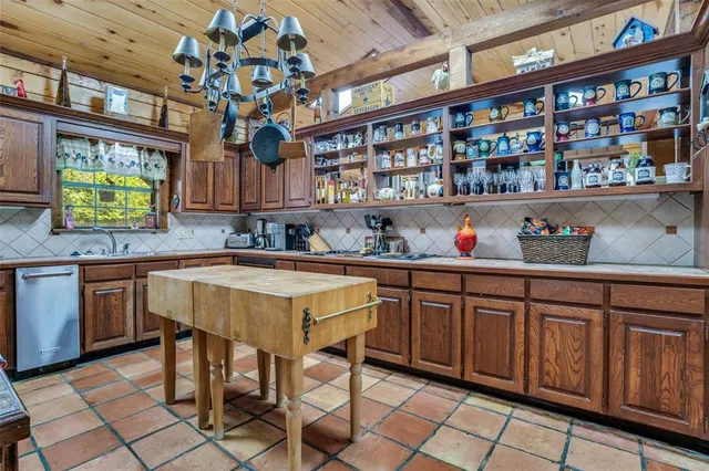 a kitchen with stainless steel appliances granite countertop a sink and a wooden cabinets