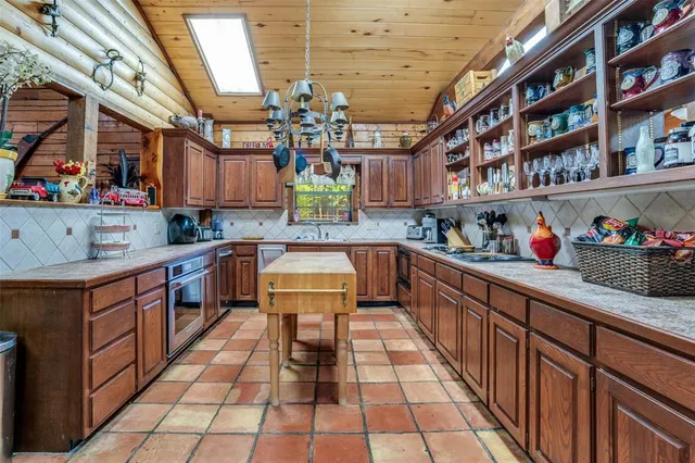 a kitchen with stainless steel appliances granite countertop a sink and cabinets