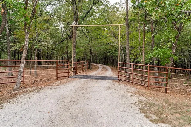 a view of a park with wooden fence