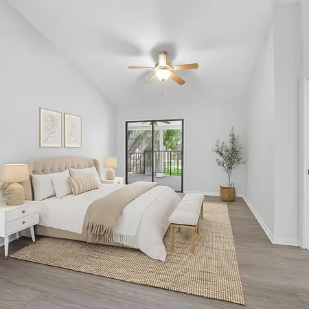 a bedroom with a large bed and a chandelier