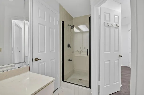 a bathroom with a shower and a sink