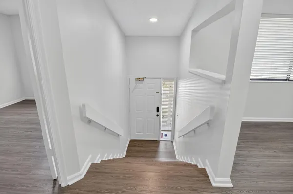 a view of entryway with stairs and wooden floor