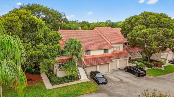 an aerial view of a house with garden space and street view