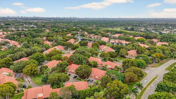 an aerial view of residential houses with outdoor space and trees