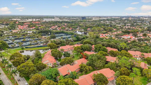 an aerial view of lake and residential houses with outdoor space