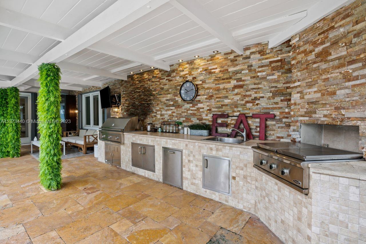 1401 South Ocean Drive Fort Lauderdale, FL 33316 - Photo 13 of 26 a kitchen with stainless steel appliances granite countertop a stove a sink and a refrigerator