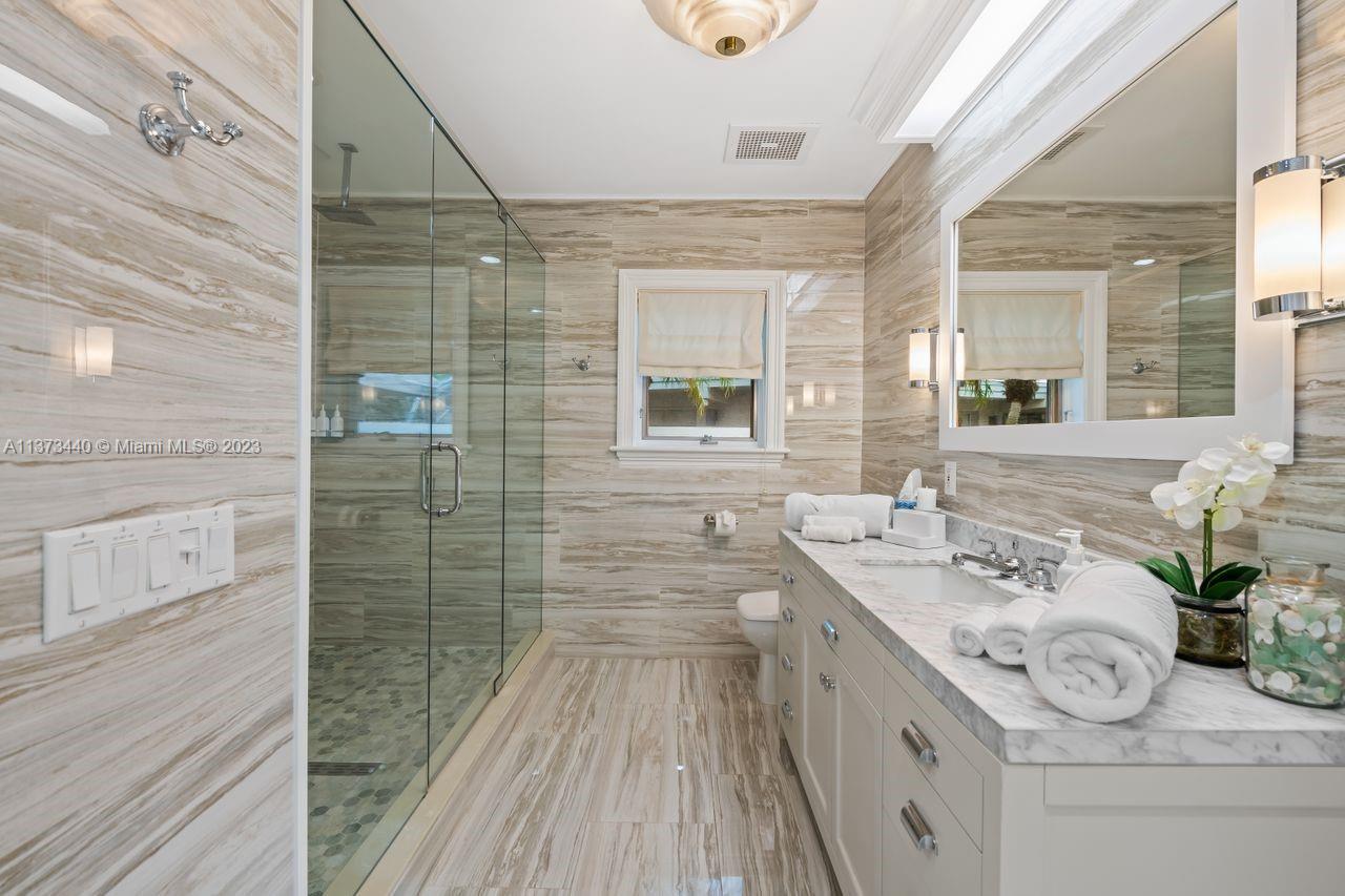 1401 South Ocean Drive Fort Lauderdale, FL 33316 - Photo 25 of 26 a bathroom with a sink mirror and a shower