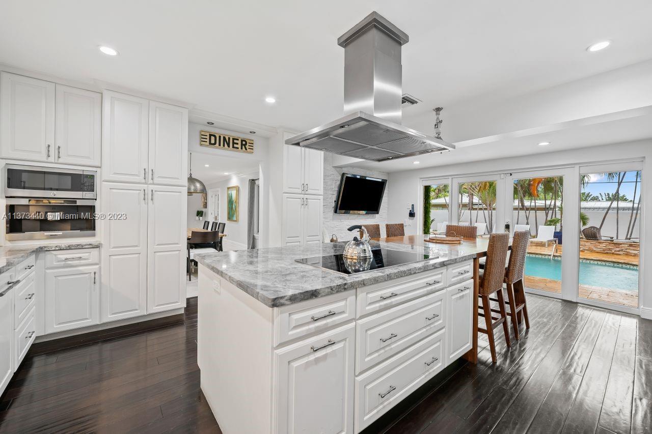 1401 South Ocean Drive Fort Lauderdale, FL 33316 - Photo 7 of 26 a kitchen with white cabinets and appliances