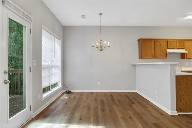 a view of a room with wooden floor and windows