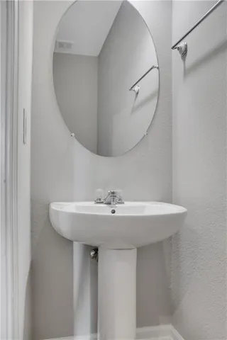 a bathroom with a sink a mirror and a vanity