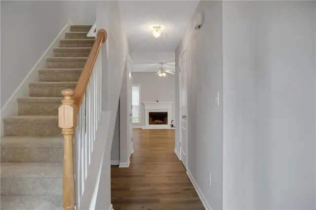a view of a hallway with wooden floor and entryway