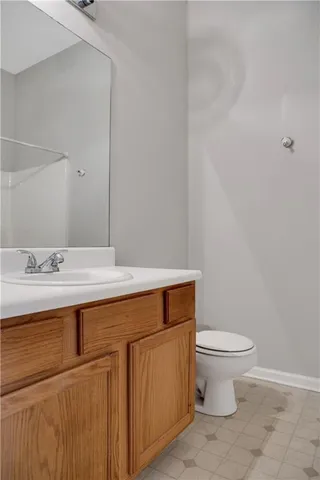 a bathroom with a sink a toilet and mirror