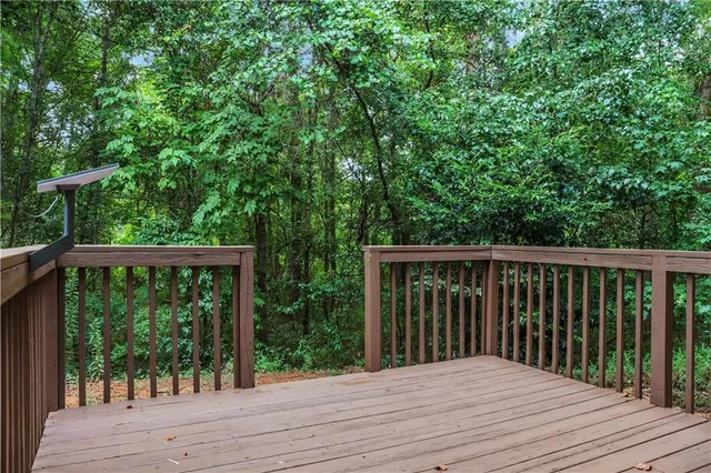 a balcony with wooden floor and outdoor space