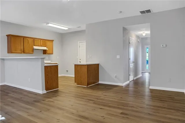 a view of a room with wooden floor and cabinet